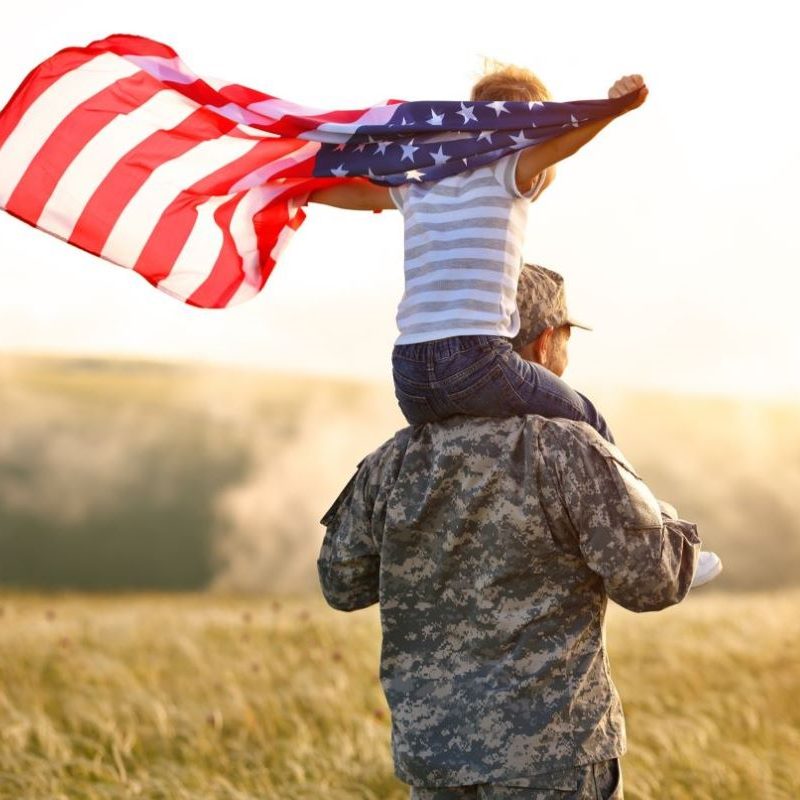 Veteran-with-child-holding-flag